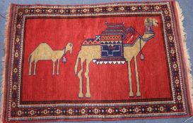 A Persian rug, decorated with camels, 4ft 9in. x 3ft 2in.