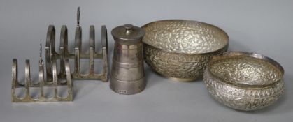 Two silver toastracks, a silver pepper mill and two Indian white metal bowls.