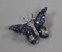 A modern 18ct white gold, sapphire and diamond set butterfly brooch, diameter 26mm.