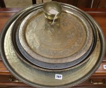 A pewter plate and three brass trays etc