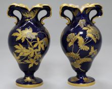 A pair of Spode blue ground baluster vases, gilt decorated with flowering shrubs 7in.