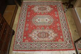 A Persian style red ground rug, 5ft 8in. x 4ft 5in.