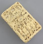 A Chinese export ivory card case, 19th century, carved in high relief and openwork with figures amid