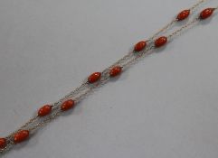 An early 20th century 9ct gold and coral bead set guard chain, gross weight 15.7 grams, 126cm.