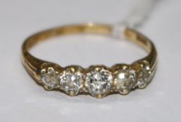 An 18ct gold and five stone diamond ring, size S.