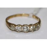 An 18ct gold and five stone diamond ring, size S.