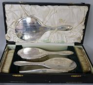 A cased George V silver six piece brush and mirror set, Colen Hewer Cheshire, Chester, 1921.
