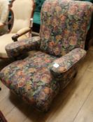 A Victorian club armchair, with floral upholstery, on short turned legs