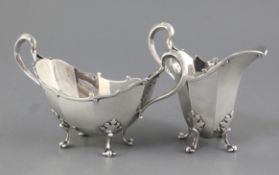 A George V Asprey & Co Ltd silver helmet shaped cream jug and boat shaped two handled sugar bowl, of