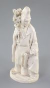 A Japanese ivory okimono of priest and a child, Meiji period, the priest standing and holding a