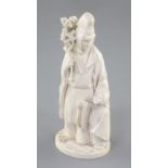 A Japanese ivory okimono of priest and a child, Meiji period, the priest standing and holding a