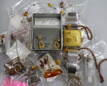 A collection of translucent and faux amber jewellery, some silver-mounted, a pair of Trifari