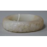 A Chinese white and russet jade bangle