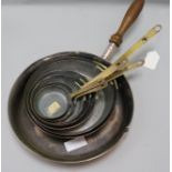 A set of graduated copper pans