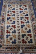 A Persian floral cream ground rug, 5ft 4in. x 3ft 5in.