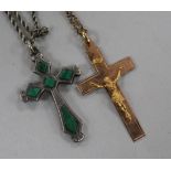 A gold crucifix pendant and a silver and malachite cross pendant.