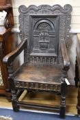 An antique carved oak Wainscot chair, bearing the date 1671