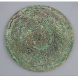 A Chinese bronze circular mirror, Western Han dynasty, 2nd century B.C. cast in low relief with