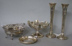 A pierced silver oval dish, a similar circular pedestal dish, a coin-inset dish and a pair of