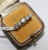 An early 20th century 18ct gold and graduated five stone ring, size O.