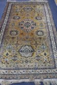 A Persian style yellow ground rug, 9ft x 5ft 6in.