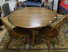 An Ercol oak drop leaf dining table and four chairs