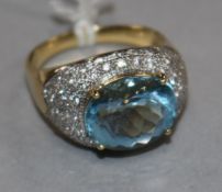 A modern 18ct gold, aquamarine and diamond cluster ovoid dress ring, size R.