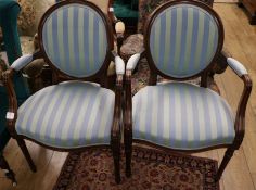A pair of Hepplewhite style elbow chairs, on turned fluted supports