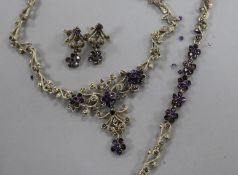 A silver, paste and marcasite demi parure, comprising a necklace, bracelet and pair or earrings.