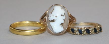 A 22ct gold wedding band, a 9ct gold cameo ring and a 9ct gold gem set ring.