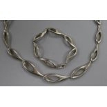 A contemporary silver necklace and matching bracelet.