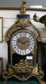 A Louis XV style ebonised eight day chiming mantel clock on matching stone, Clock H.75cm, Stand H.