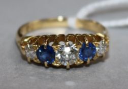 An early 20th century 18ct gold and graduated five stone sapphire and diamond ring, size R.