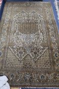 A Tabriz style cream ground rug, worked with a central medallion of urns and stylised flowers, 7ft x