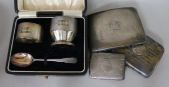 Two silver cigarette cases, a silver match sleeve and a cased silver christening set.