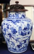 A Chinese vase, transitional period c. 1640, blue and white Hundred Boys wood stand and cover