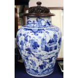 A Chinese vase, transitional period c. 1640, blue and white Hundred Boys wood stand and cover