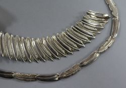 A contemporary silver 'feather' necklace and matching bracelet.