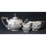 A late Victorian silver three piece tea set by Edward Hutton, London, 1893 and a pair of Irish