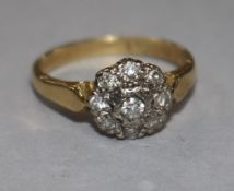 A diamond cluster ring, illusion-set in platinum on 18ct yellow gold shank