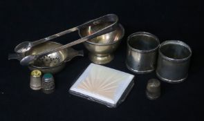 A small group of silver including Art Deco silver and enamel cigarette case, tea strainer and napkin