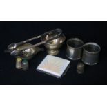 A small group of silver including Art Deco silver and enamel cigarette case, tea strainer and napkin