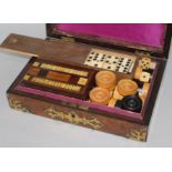 A Victorian walnut and brass games box and contents 26cm. H.18cm.