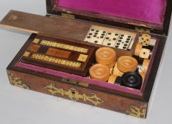 A Victorian walnut and brass games box and contents 26cm. H.18cm.