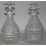 A pair of Regency cut glass decanters 21.5cm.