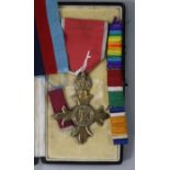 A cased O.B.E. medal