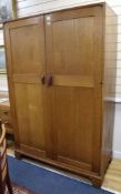 A Gordon Russell oak two door wardrobe W.122cm H.183cm