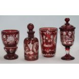Four items of Bohemian ruby flashed glass, including a panel-cut beaker engraved with decorative