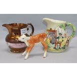 A Beswick model of a calf and a Staffordshire musical pottery jug and a lustre jug