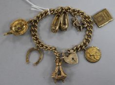 A 9ct gold charm bracelet, the curb-link chain with heart-shaped padlock clasp and hung with seven